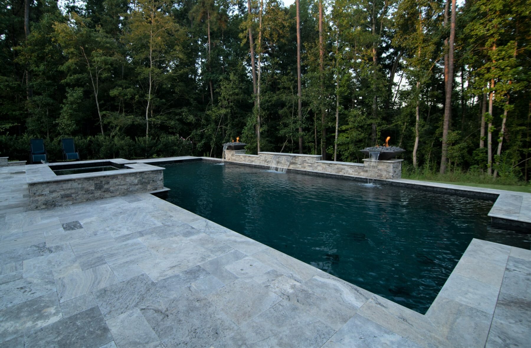 Modern inground pool with raised spa, sheer descents and fire features in Charlotte, NC.