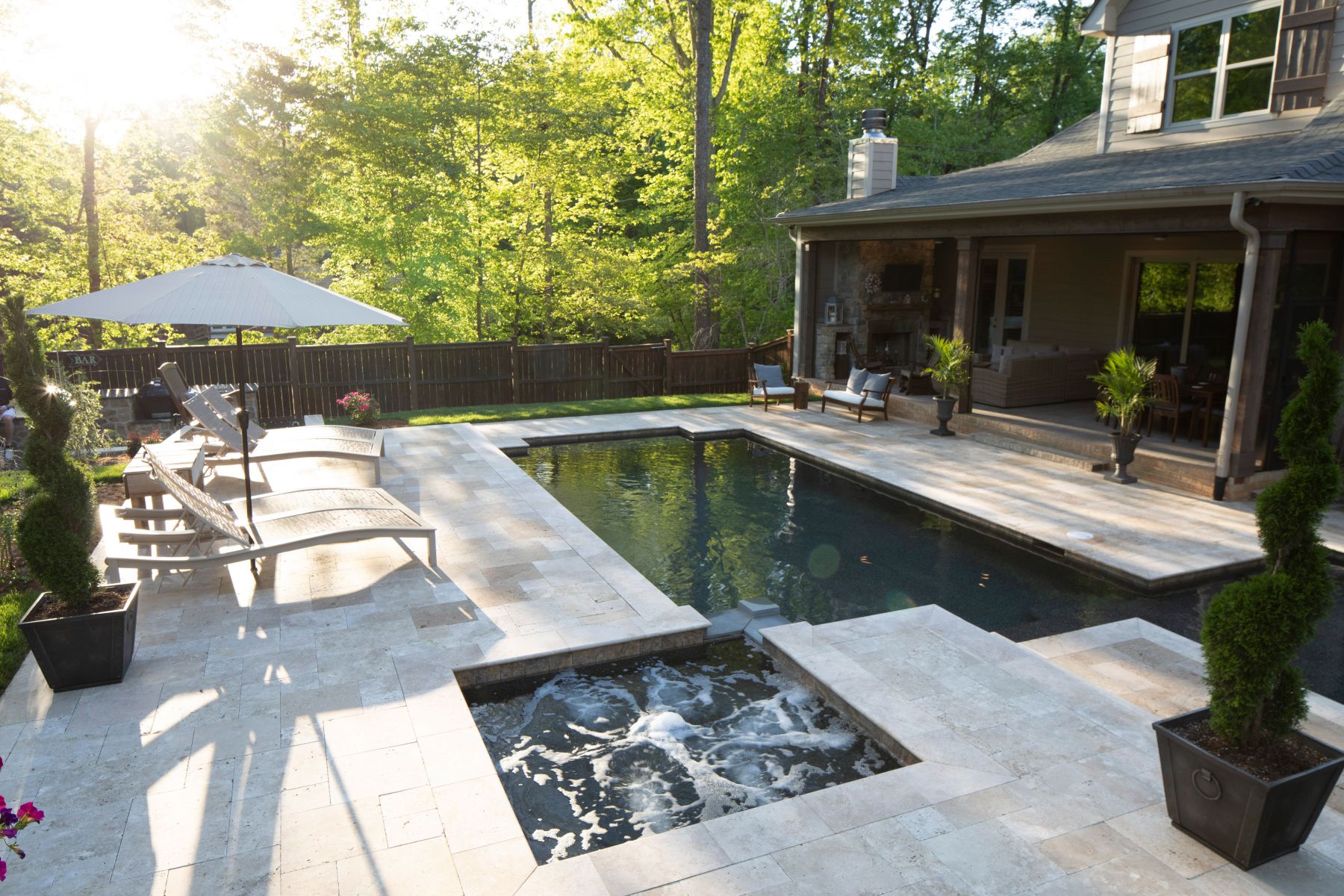 Geometric pool with travertine decking